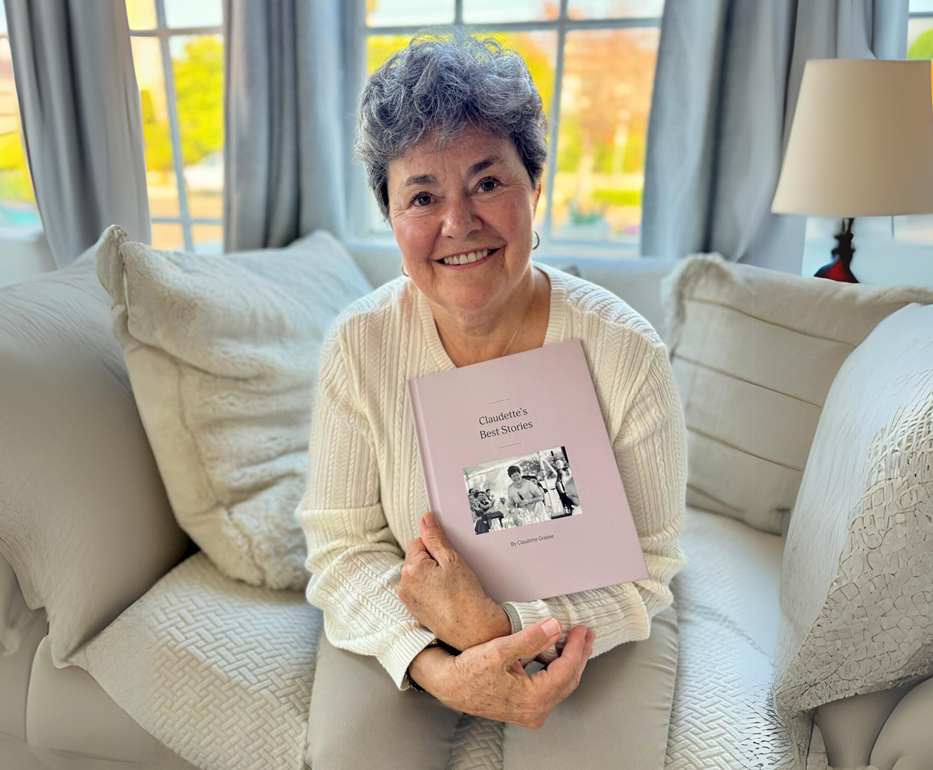 Photo of a woman holding a book.