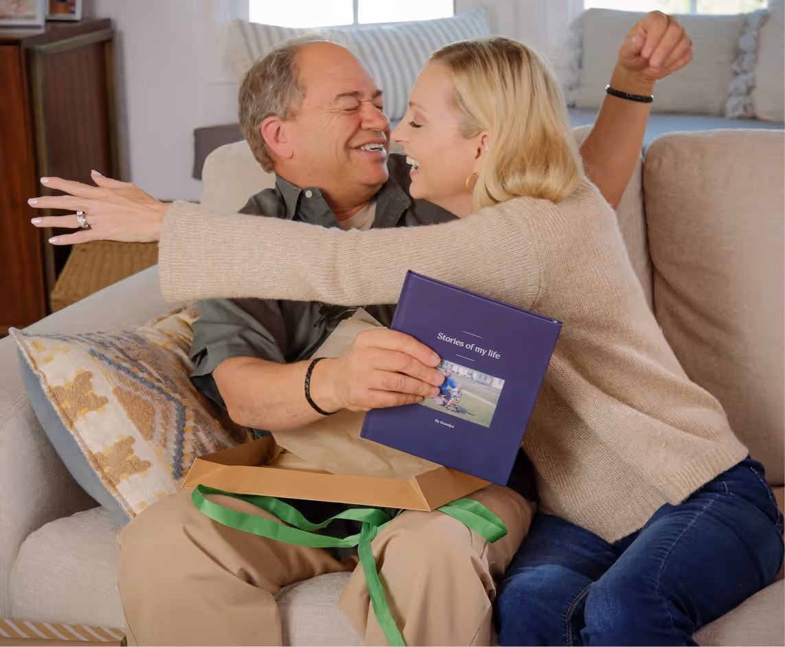 Photo of a man holding a phone. He looks like he is telling a story