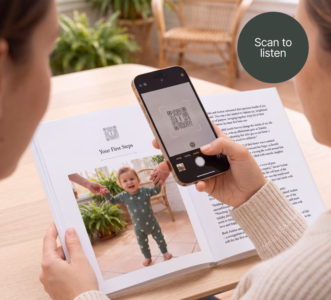 A picture of the Remento book opened on a story. The first page has a QR code, a title, and a photo