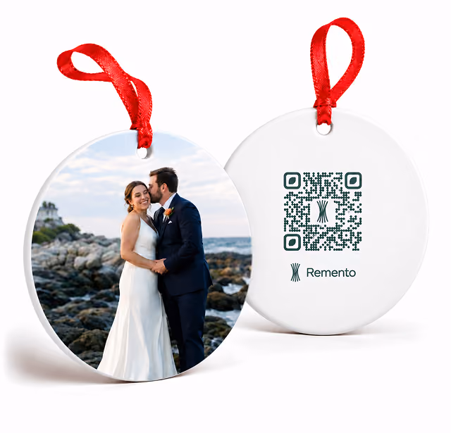 Newlyweds kissing by the ocean on a first Christmas married photo ornament with QR code back