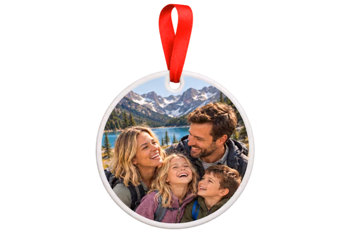 Ceramic travel photo ornament with red ribbon showing a family selfie by a mountain lake
